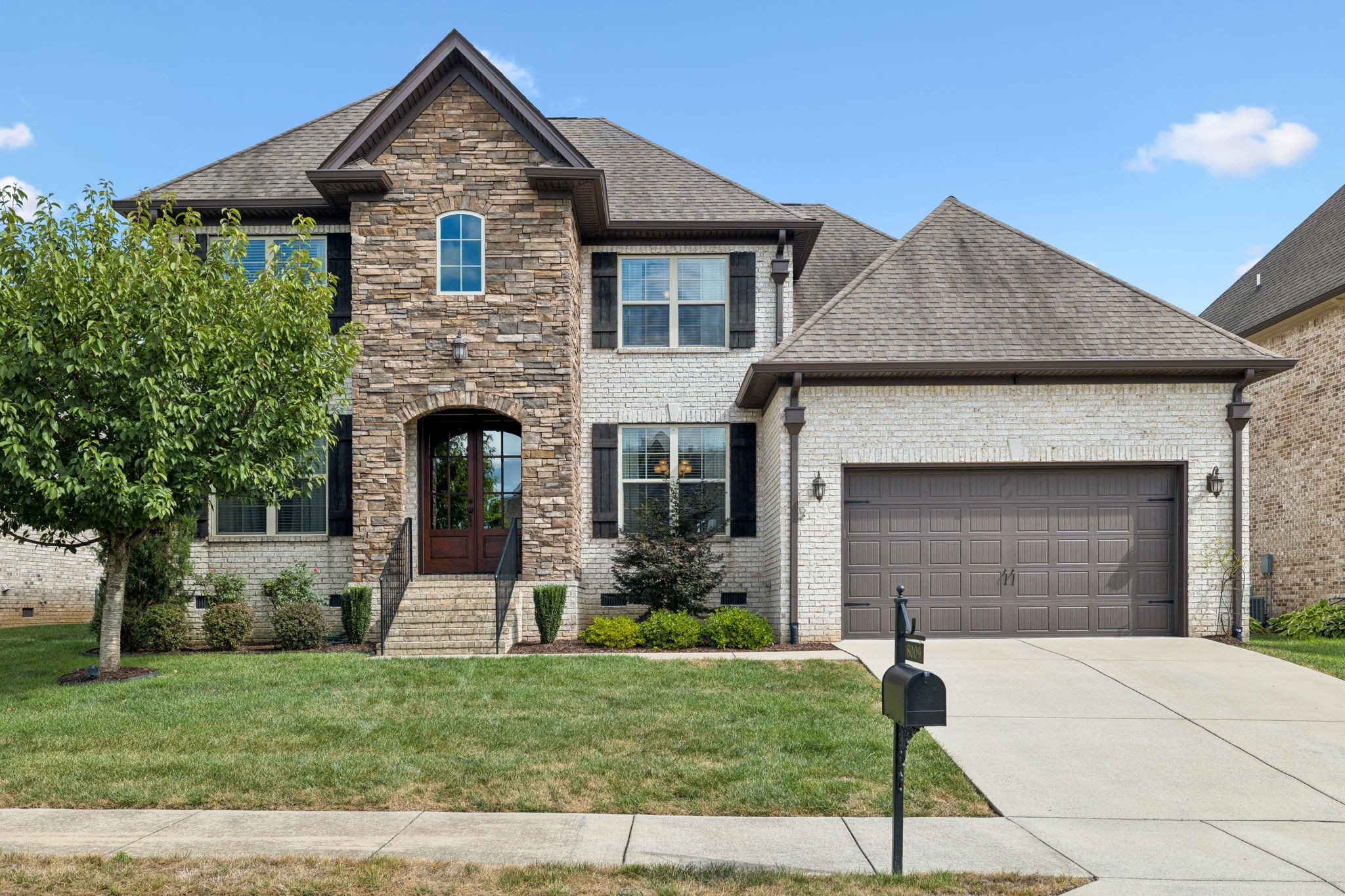 8009 June Apple Lane Spring Hill, TN 37174 - Photo 1 of 69 a front view of a house with a yard and garage