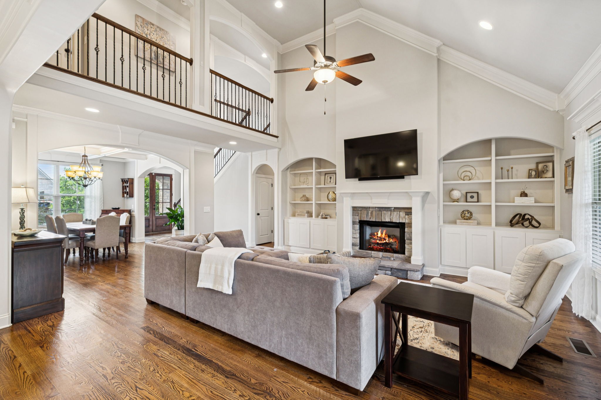 8009 June Apple Lane Spring Hill, TN 37174 - Photo 18 of 69 a living room with furniture a flat screen tv and a fireplace