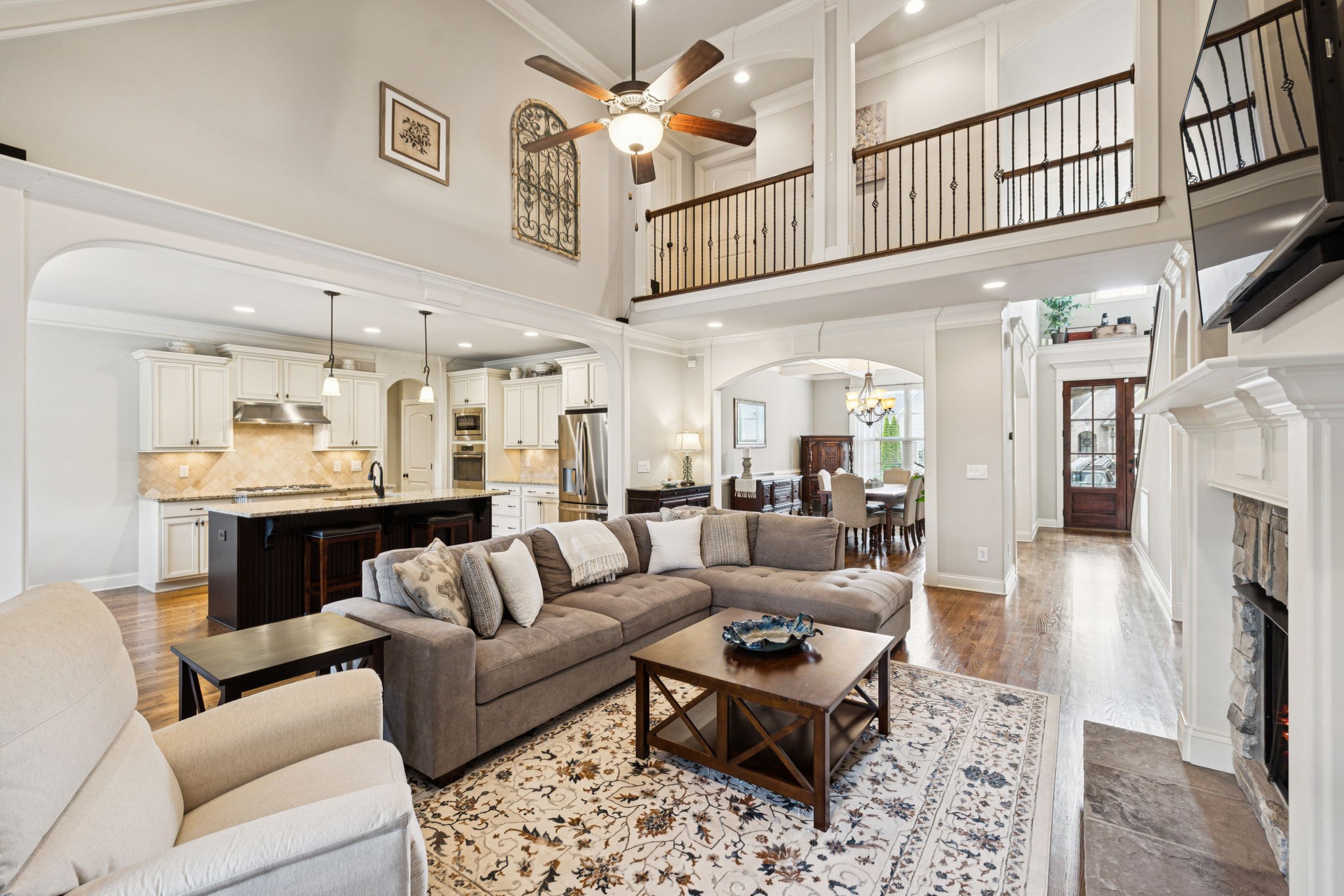 8009 June Apple Lane Spring Hill, TN 37174 - Photo 20 of 69 a living room with furniture a fireplace and a chandelier