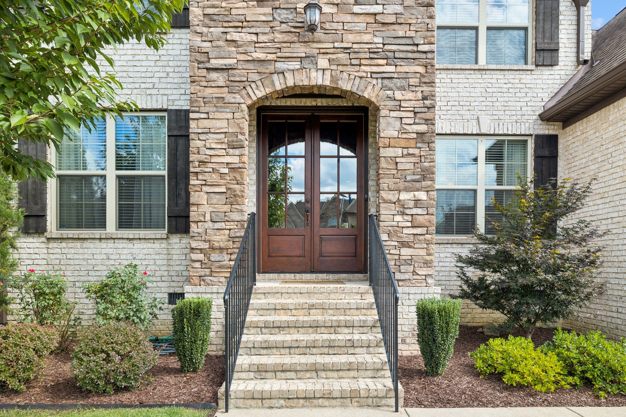8009 June Apple Lane Spring Hill, TN 37174 - Photo 4 of 69 a front view of a house with a garden