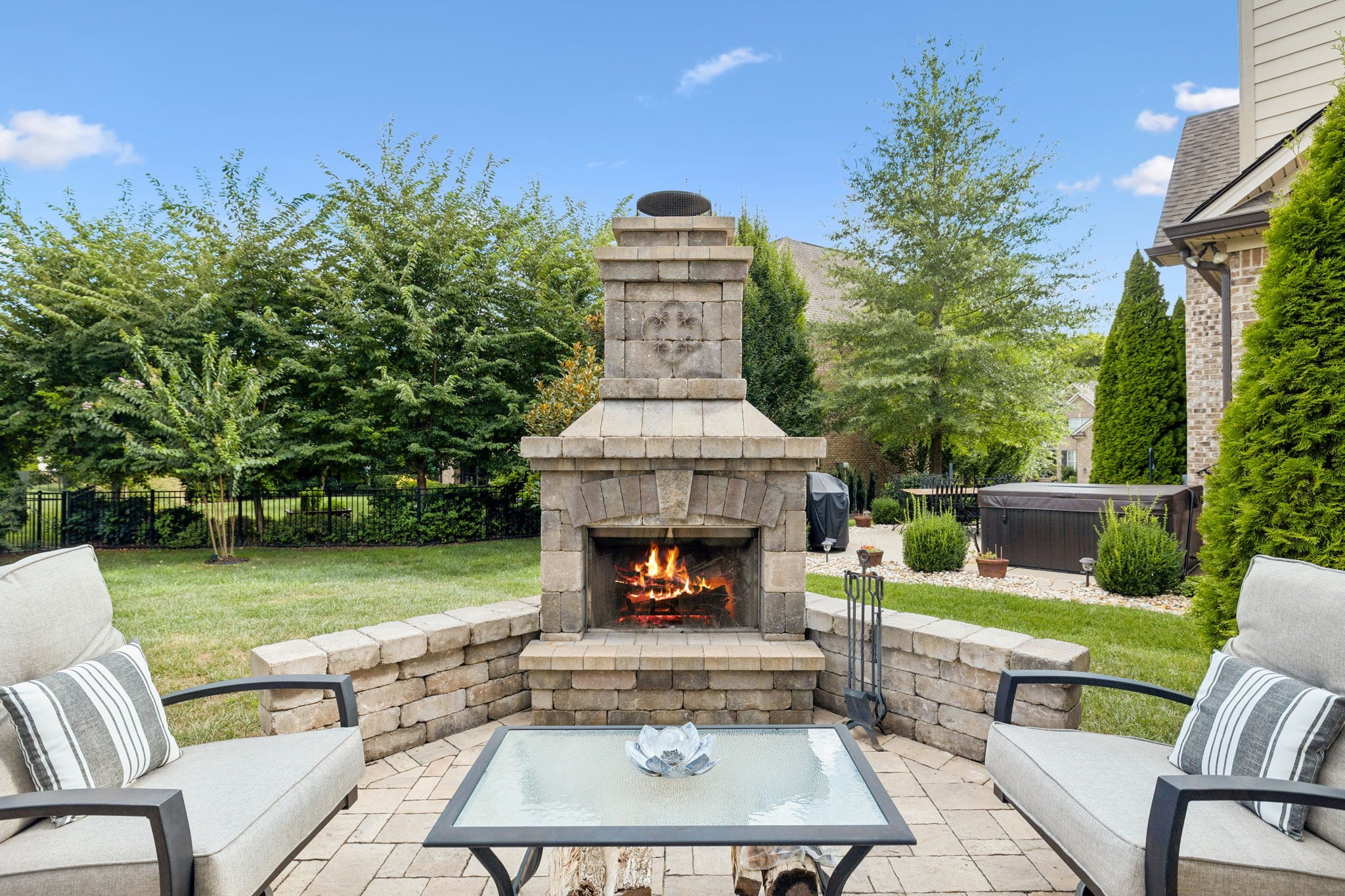 8009 June Apple Lane Spring Hill, TN 37174 - Photo 60 of 69 a view of a patio with couches table and chairs with floor to ceiling window and yard