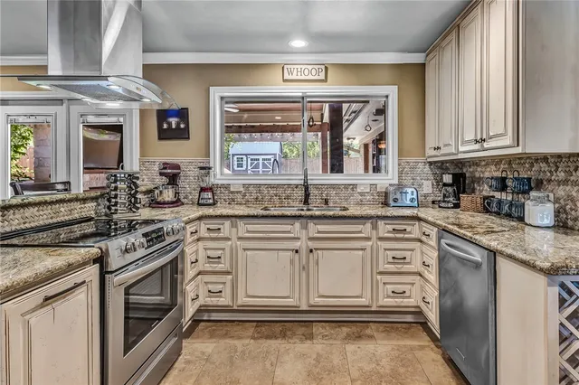 a kitchen with stainless steel appliances granite countertop a stove and cabinets