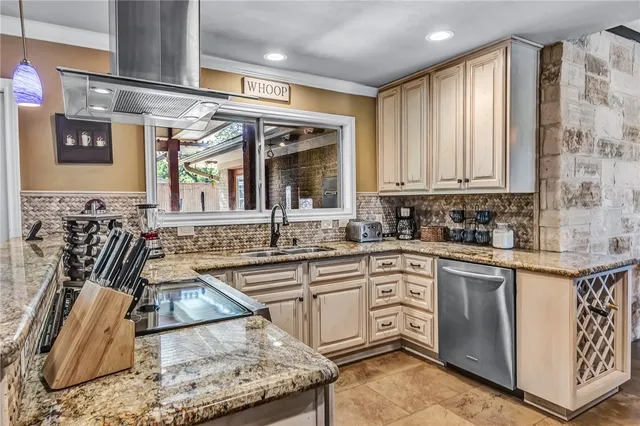 a kitchen with stainless steel appliances granite countertop a sink stove and cabinets