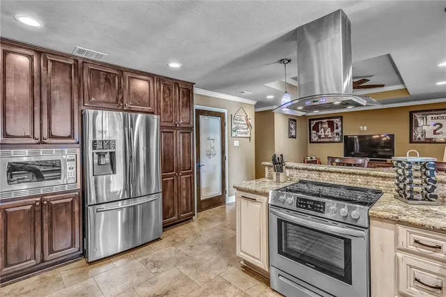 a kitchen with stainless steel appliances granite countertop a stove a refrigerator and a refrigerator