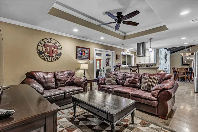 a living room with furniture and a ceiling fan