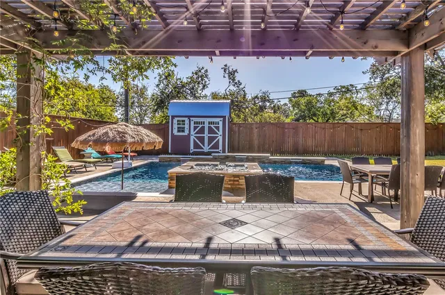 a view of a chairs and table in backyard