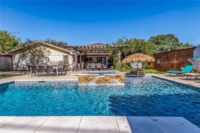 a view of swimming pool with outdoor seating and deck
