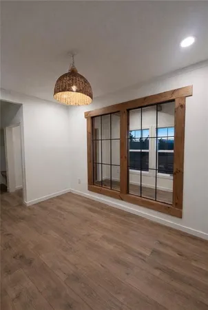 a kitchen with granite countertop a stove and a wooden floors