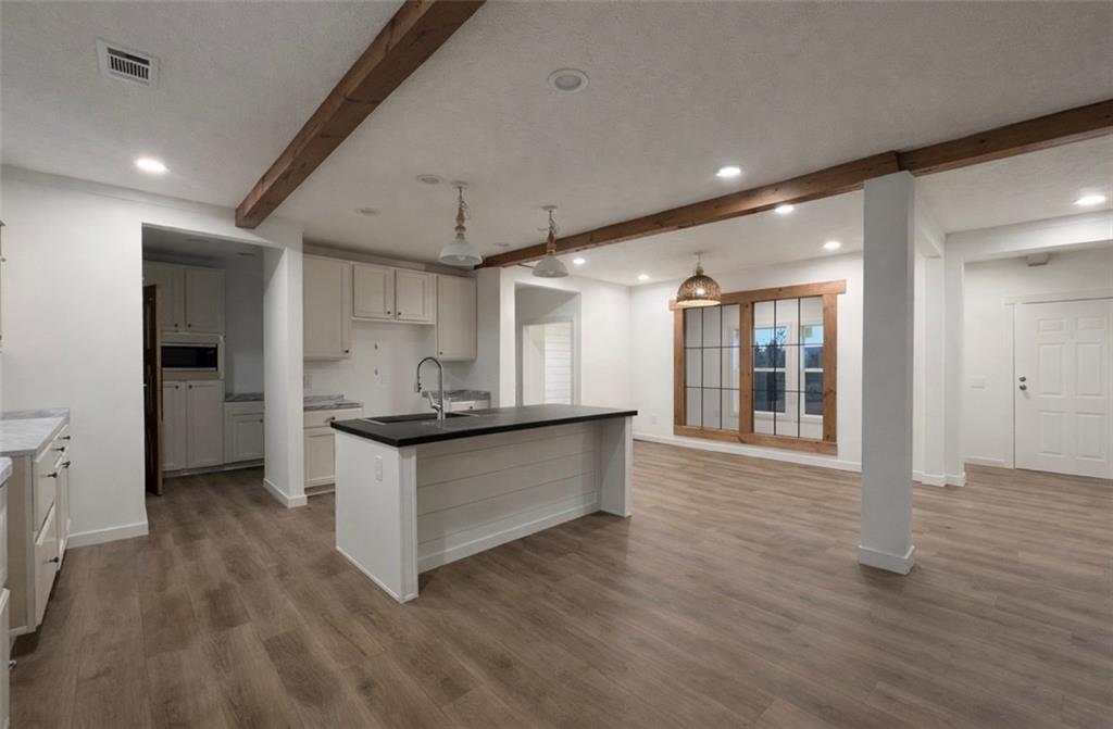 1590 Buttermilk Road Southwest Cave Spring, GA 30124 - Photo 18 of 43 a kitchen with granite countertop a stove and a wooden floors
