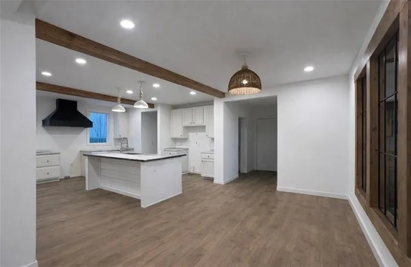 a kitchen with granite countertop white cabinets and a sink
