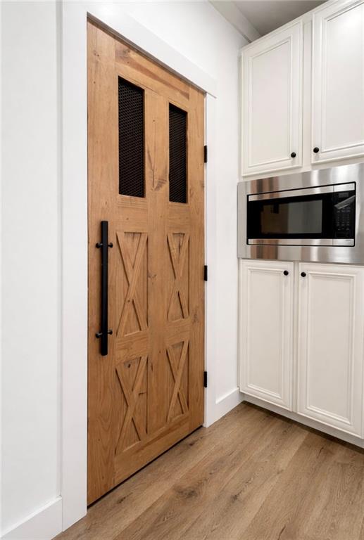 1590 Buttermilk Road Southwest Cave Spring, GA 30124 - Photo 21 of 43 a view of an empty room with wooden floor and cabinet