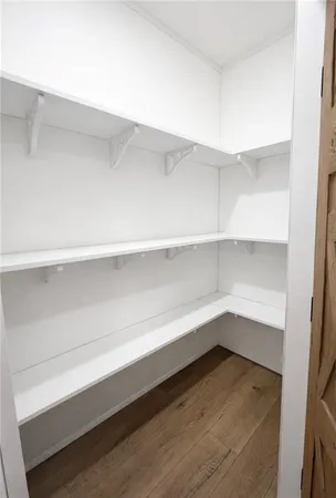 a kitchen with sink cabinets and wooden floor