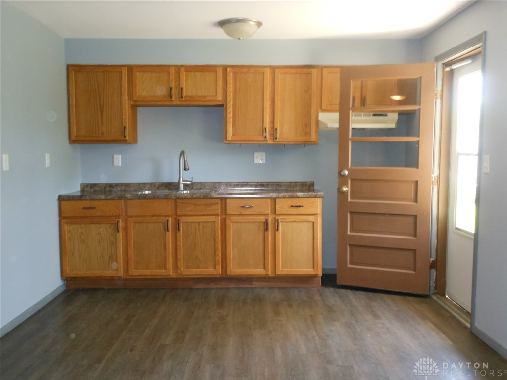 143 West Emerick Road West Milton, OH 45383 - Photo 7 of 37 This spacious kitchen offers ample cabinet storage and convenient outdoor access.