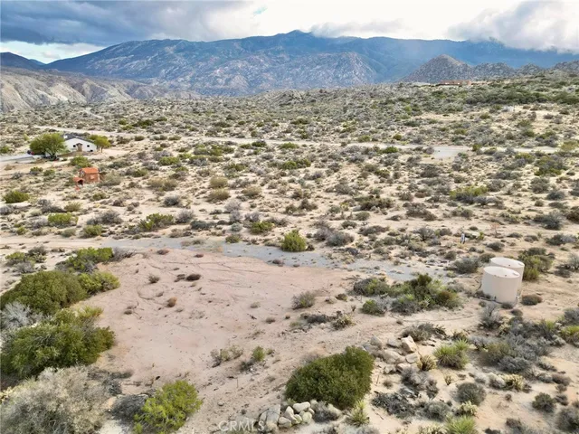 an aerial view of mountain with yard
