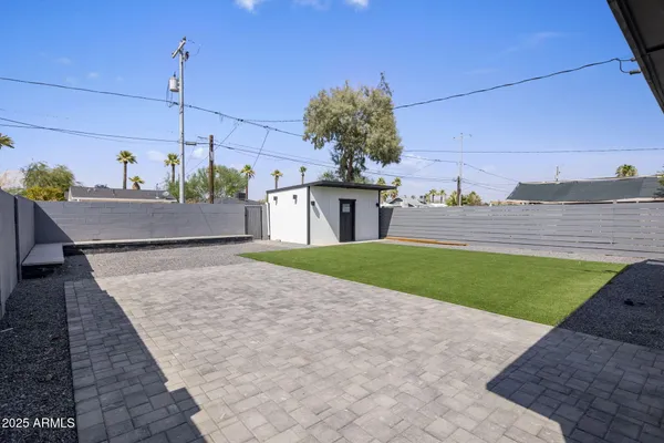 a view of a house with a yard and potted plants