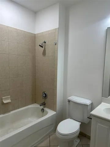 a white toilet sitting next to a bath tub