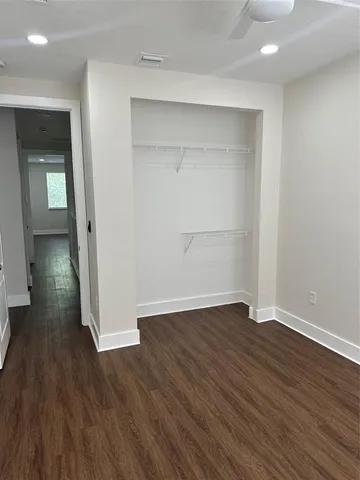 a view of a room with wooden floor and closet
