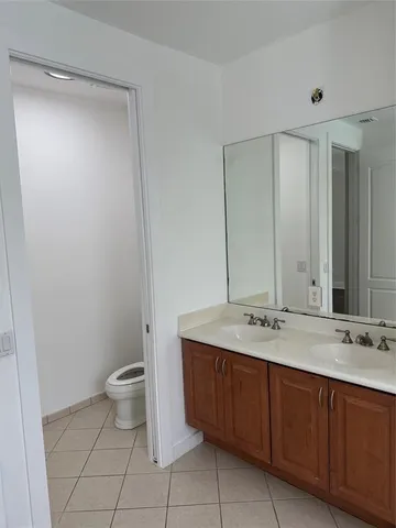 a bathroom with a sink a toilet and mirror