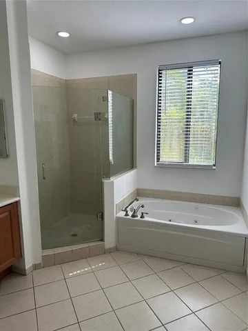 a bathroom with a bathtub a shower and a sink