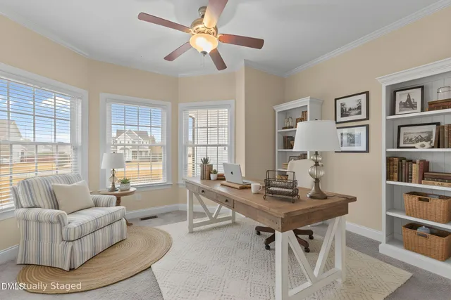 a view of a house with a barbeque and wooden stairs