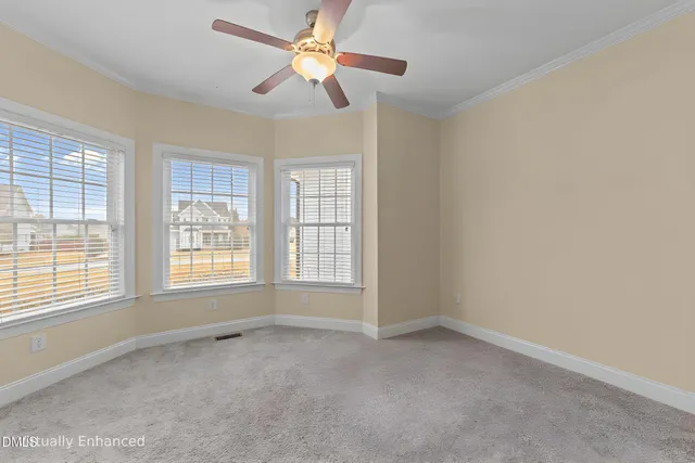 a view of staircase with lots of frames on wall and wooden floor