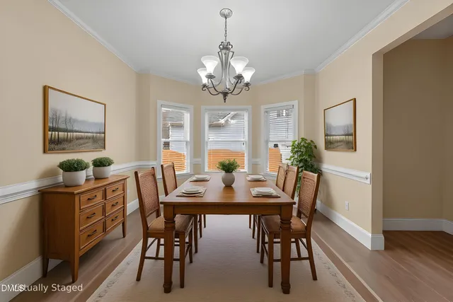 a kitchen with kitchen island granite countertop a sink a counter top space stove and cabinets