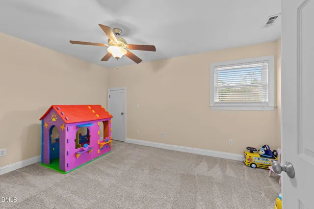 a living room with flat screen tv and glass door