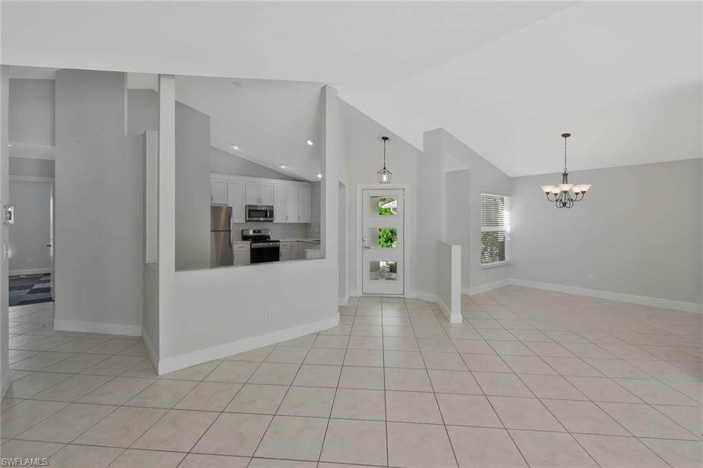 11054 Linnet Lane Naples, FL 34119 - Photo 11 of 50 an empty room with kitchen view and a window
