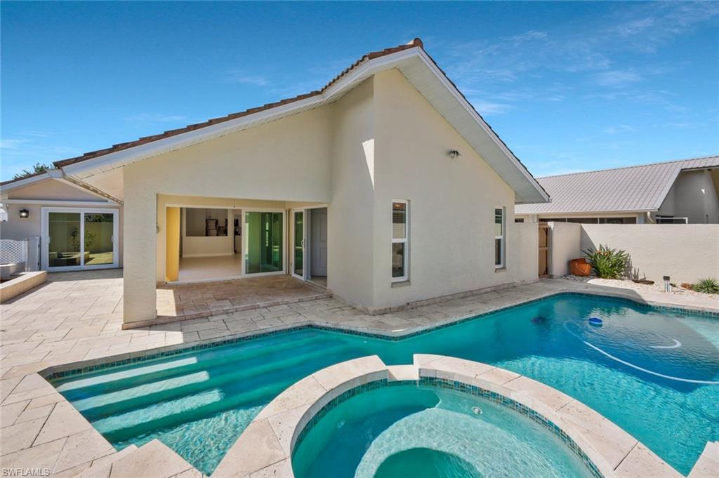 11054 Linnet Lane Naples, FL 34119 - Photo 2 of 50 a front view of a house with a yard