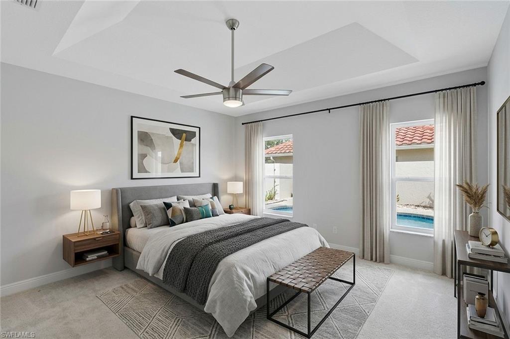 11054 Linnet Lane Naples, FL 34119 - Photo 22 of 50 a bedroom with a bed and a chandelier