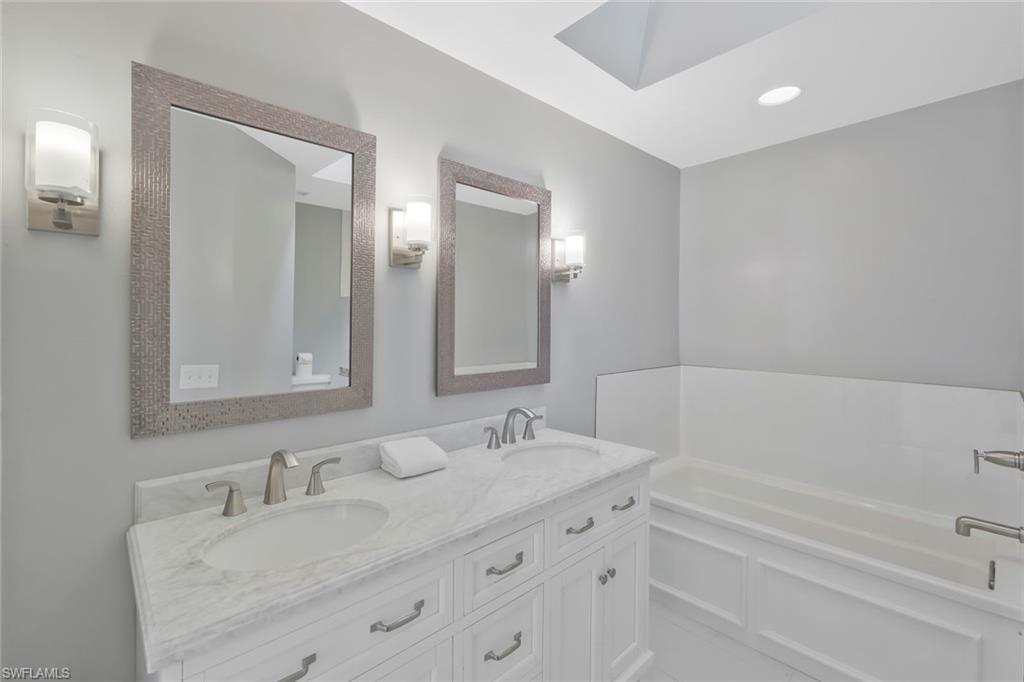 11054 Linnet Lane Naples, FL 34119 - Photo 24 of 50 a bathroom with a granite countertop sink mirror and double