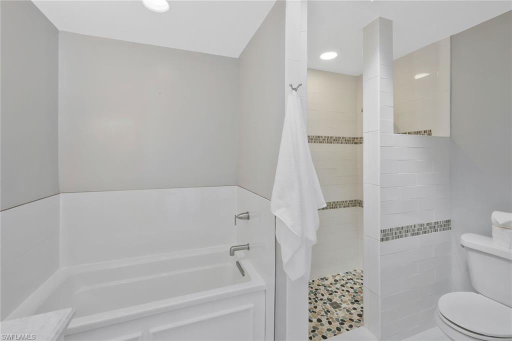 11054 Linnet Lane Naples, FL 34119 - Photo 25 of 50 a bathroom with a bathtub and a toilet