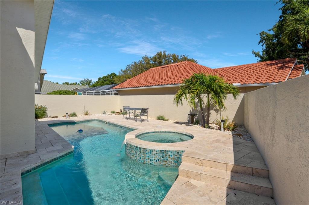11054 Linnet Lane Naples, FL 34119 - Photo 3 of 50 a view of a swimming pool with lounge chair