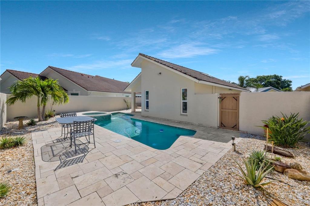 11054 Linnet Lane Naples, FL 34119 - Photo 36 of 50 a backyard of a house with table and chairs