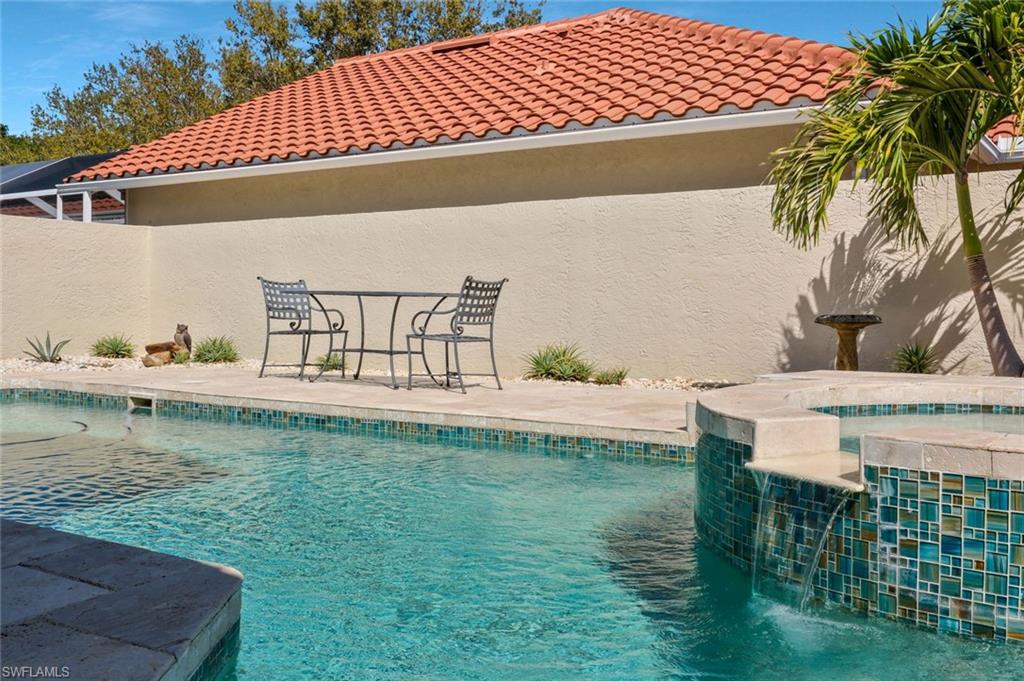 11054 Linnet Lane Naples, FL 34119 - Photo 38 of 50 a view of a swimming pool with a patio