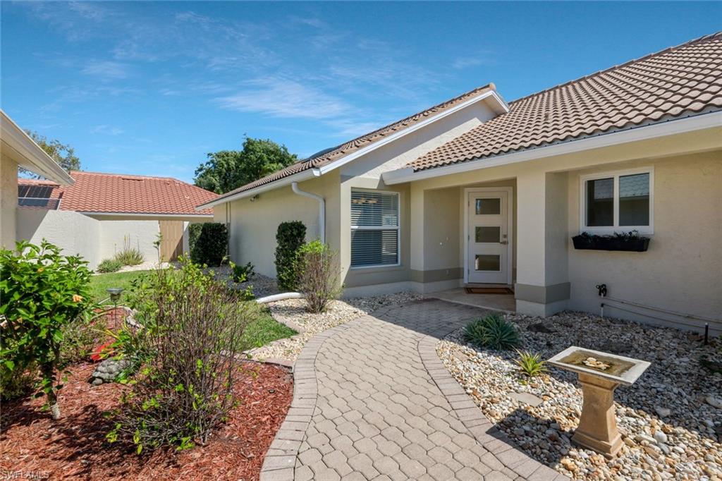 11054 Linnet Lane Naples, FL 34119 - Photo 4 of 50 a front view of a house with garden