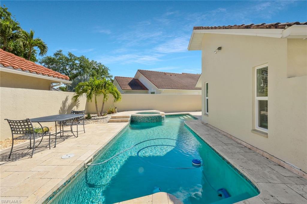 11054 Linnet Lane Naples, FL 34119 - Photo 40 of 50 swimming pool view with a garden space