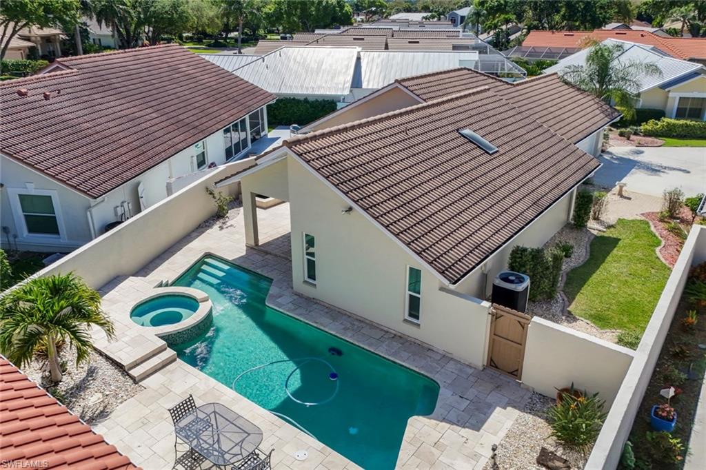 11054 Linnet Lane Naples, FL 34119 - Photo 41 of 50 a view of a patio with table and chairs with wooden floor and fence