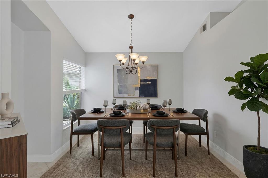 11054 Linnet Lane Naples, FL 34119 - Photo 7 of 50 a view of a dining room with furniture window and wooden floor