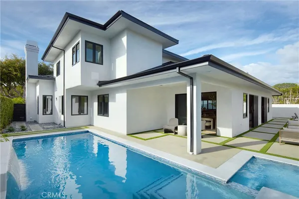 a view of a house with pool and wooden floor