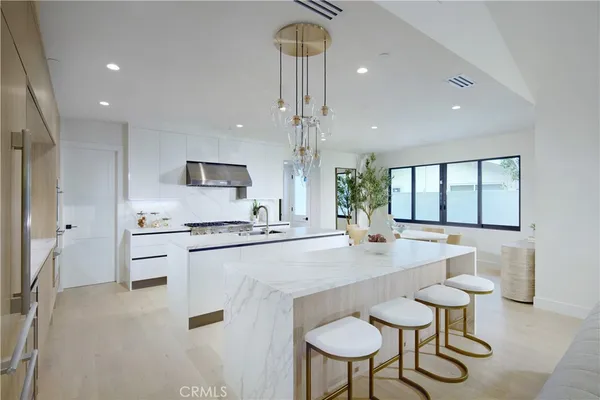a large kitchen with sink cabinets and stainless steel appliances