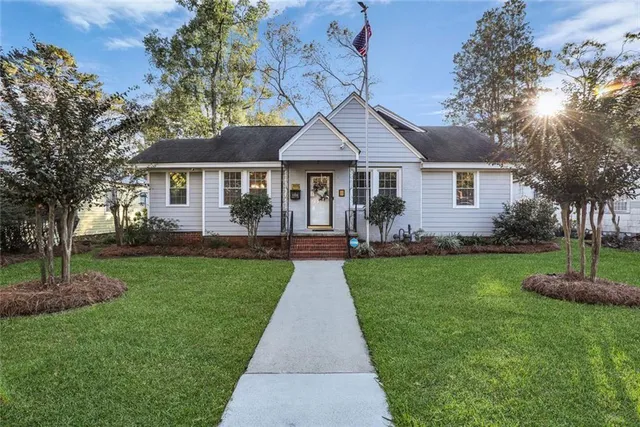 a front view of a house with a garden
