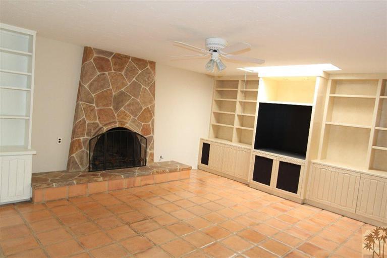 71371 Biskra Road Rancho Mirage, CA 92270 - Photo 1 of 39 a view of empty room with a fireplace and wooden floor