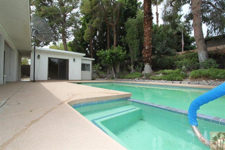 71371 Biskra Road Rancho Mirage, CA 92270 - Photo 12 of 39 a front view of a house with a yard and trees