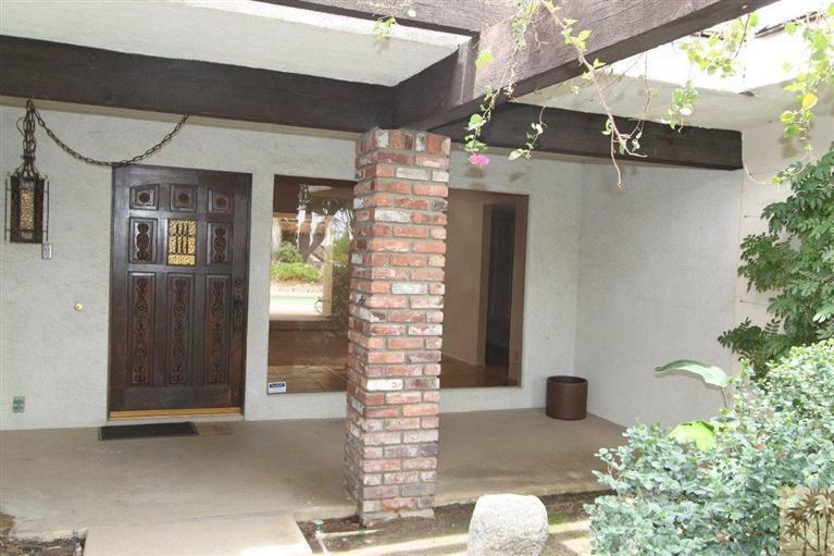 71371 Biskra Road Rancho Mirage, CA 92270 - Photo 13 of 39 a front view of a house with a garage