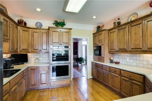 1475 Ridley Drive Franklin, TN 37064 - Photo 6 of 20 A cook's kitchen with abundant maple cabinets, almost new stainless appliances. Double oven, microwave, dishwasher, electric cooktop with downdraft. Solid surface counter tops, eat at bar.