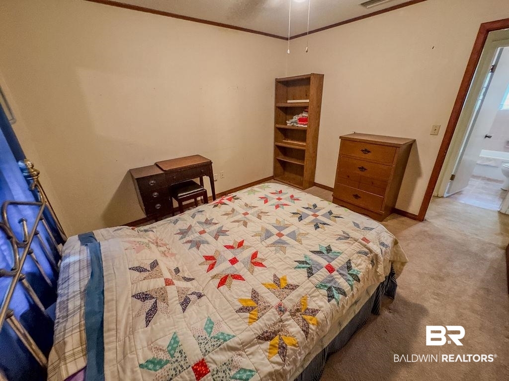 1456 Allen Walker Road Grove Hill, AL 36451 - Photo 20 of 28 Carpeted bedroom featuring crown molding and baseboards