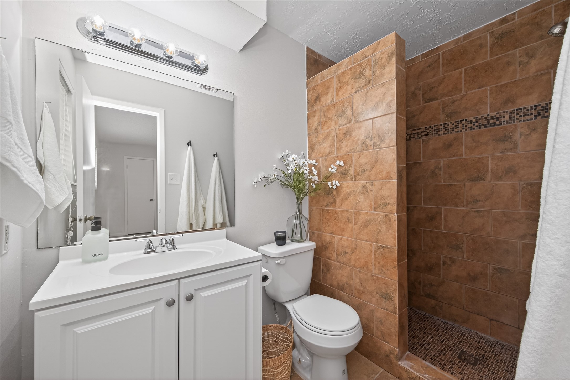 23919 Farm Hill Drive Spring, TX 77373 - Photo 34 of 41 a bathroom with a sink and mirror with toilet