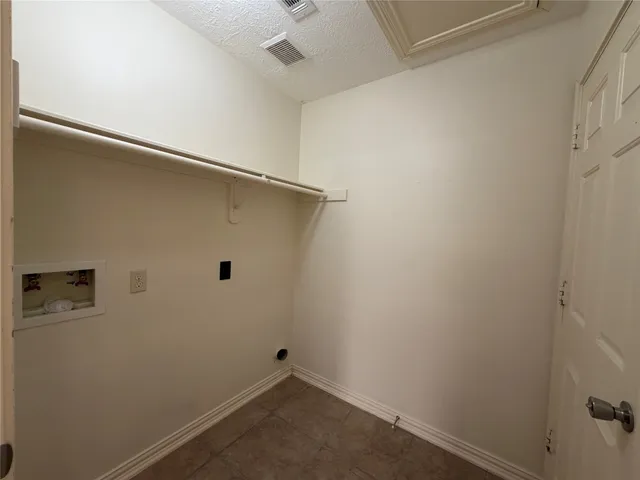 a view of empty room with wooden floor and fireplace
