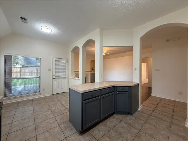 a kitchen with a refrigerator and a sink